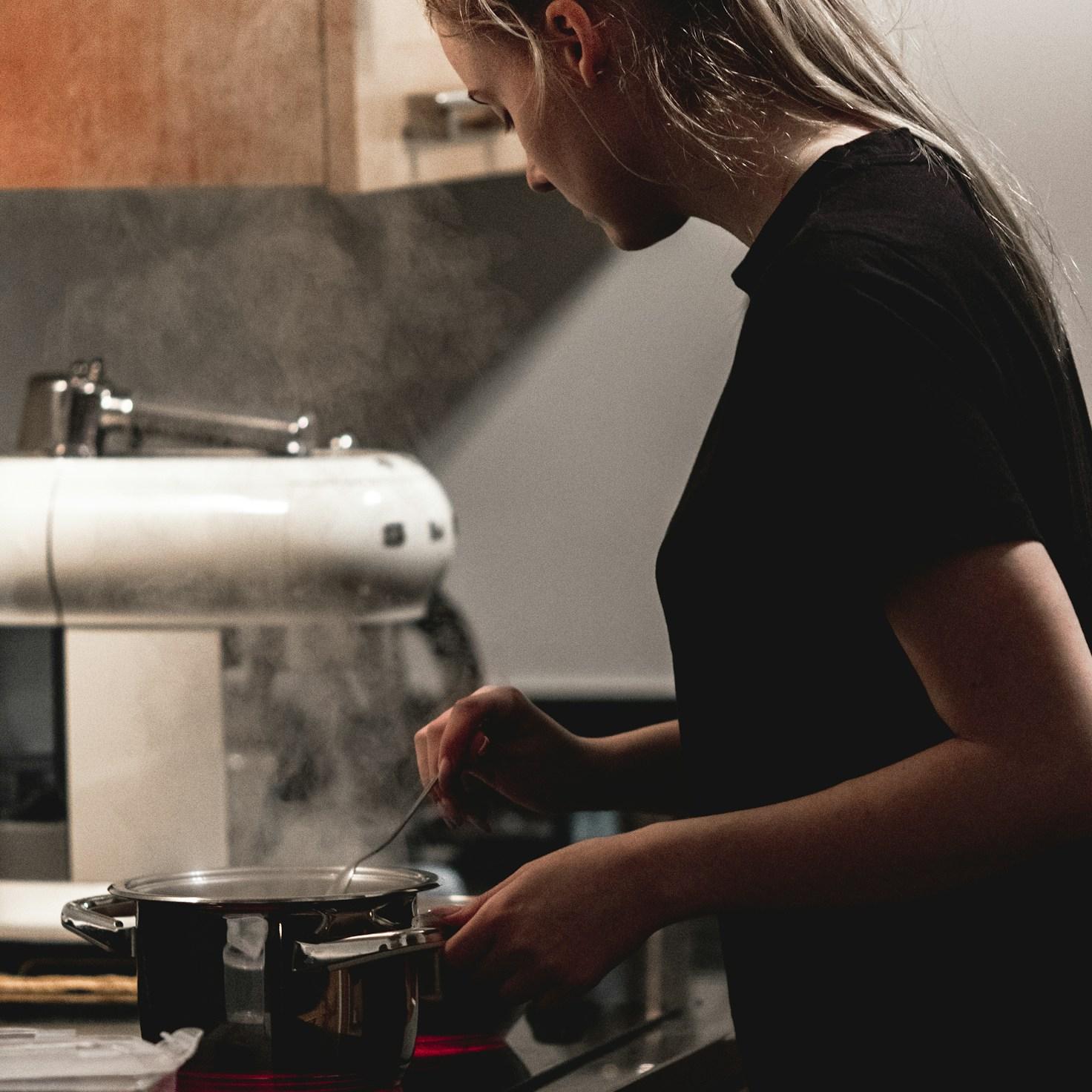 Community members collaborating in a modern kitchen space, exchanging recipes and techniques